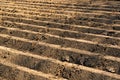 Furrows row pattern in a plowed field prepared for planting crops in spring