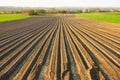 Furrows row pattern in a plowed field prepared for planting.