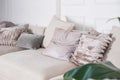 Furry pillow, shiny pink cushions on the king size bed.cozy home interior decor in beige and pink colors.trendy bedroom Royalty Free Stock Photo