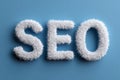 Furry white letters forming seo acronym on minimal blue background representing search engine optimization Royalty Free Stock Photo