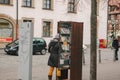 Furth, Germany, December 28, 2016: A woman chooses a book. Street public library. Education in Germany. Lifestyle