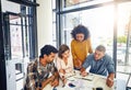 Furthering their reach through new markets. a team of designers having a meeting in an office. Royalty Free Stock Photo