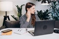 Furuncle, earache, shingles, eczema, ear disease, otitis concept. Upset young woman 20s old years sit on couch at table working Royalty Free Stock Photo