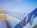 Fuselage of airplane with door and windows. Row of portholes outside the passenger aircraft. Plane on bly sky background Royalty Free Stock Photo