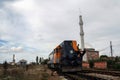 Diesel locomotive shunting in Kosovo Polje depot station with a muslim mosque with a minaret in background,