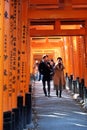 Fushimi Inari Shrine Shrine and young lovers taking pictures while walking through the gate posts