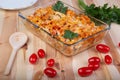 Fusili pasta baked with vegetables, tomatoes on a wooden table Royalty Free Stock Photo