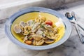 Fusilli Avellinesi pasta with clams and tomato in yellow and blue plate Royalty Free Stock Photo