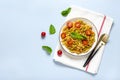 Fusilli - classic italian pasta from durum wheat with chicken meat, tomatoes cherry, basil in tomato sauce in white bowl, napkin, Royalty Free Stock Photo