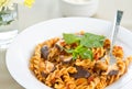 Fusilli with mushroom in tomato sauce