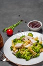 Fusilli pasta with chicken breast and broccoli salad in white plate Royalty Free Stock Photo
