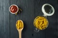 Fusilli pasta and a cup of tomato sauce Royalty Free Stock Photo