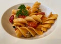 Fusilli Pasta di Gragnano with cherry tomatoes and seafood in scented oil