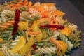 Fusilli pasta with garlic, dried red chili, yellow pepper and olive oil being cooked in a pan Royalty Free Stock Photo