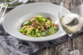 Fusilli pasta with green peas ham walnuts with white wine. italian or mediterranean cuisine