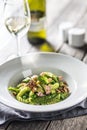 Fusilli pasta with green peas ham walnuts with white wine. italian or mediterranean cuisine