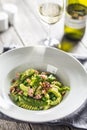 Fusilli pasta with green peas ham walnuts with white wine. italian or mediterranean cuisine