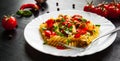 Pasta salad with tomato and olive in plate on dark wooden background Royalty Free Stock Photo