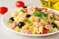 Fusilli pasta salad with tuna, tomatoes, black olives and basil on gray stone background Royalty Free Stock Photo