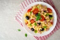 Fusilli pasta salad with tuna, tomatoes, black olives and basil on gray stone background Royalty Free Stock Photo