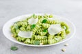Fusilli pesto pasta with pine nuts, basil leaves and parmesan cheese