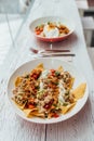 Fusion food Soboro Chicken Nachos: Japanese-style stir-fried chicken with tomato salsa, yogurt and Thai-style seafood sauce