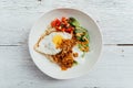 Fusion Food: Top view of Rice bowl toppings kimchi pork, organic fried egg, Korean eggplant and salad Royalty Free Stock Photo