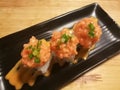 Fusion salmon sushi, stuff with cucumber, crab stick and mango, Stylist food, medium shot Royalty Free Stock Photo