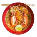 Isolated spicy thai-chinese food in thailand by top view, Tom yum koong-noodle in soup  with topping of shrimps boiled egg parsley Royalty Free Stock Photo