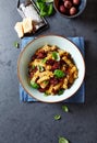 Fussili pasta with olives, shallots, dried tomatoes and parmesan