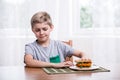 Fussy kid with chicken sandwich Royalty Free Stock Photo