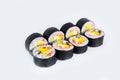 Futomaki Sushi Roll servwed on light background. Maki roll with unagi eel, mango, avocado, flying fish roe tobiko caviar and Phi Royalty Free Stock Photo