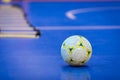 Futsal Ball on Blue Indoor Field. Blue Futsal Training Pitch.