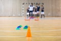 Futsal Training Field. Indoor Soccer Practice Session. Kids with Coach Training Football Royalty Free Stock Photo