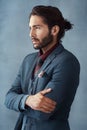 The future belongs to those with vision. Studio shot of a handsome young man looking thoughtful against a grey Royalty Free Stock Photo