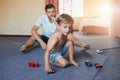 Future car enthusiast in the making. a little boy and his father playing with toy cars at home. Royalty Free Stock Photo