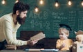 Future concept. Father teach little son to read a book, future. Future student learn reading with man teacher. Education