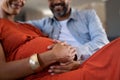 Future father feeling baby bump of pregnant woman Royalty Free Stock Photo