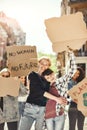 The future is female. Two happy young women are holding signboards and smiling while standing on the road around female