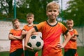 Future football champions. Little boys, kids in sports uniform posing with ball at soccer school stadium. Concept of Royalty Free Stock Photo