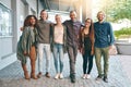 Future, here we come. Portrait of a group of happy young students standing together outdoors on campus. Royalty Free Stock Photo