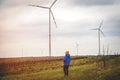 Future of kid is elternative energy. Kid on wind farm. Happy boy on vacation walking on nature. Renewable energies and Royalty Free Stock Photo