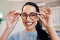 The future looks good to me. a young woman buying a new pair of glasses at an optometrist store. Royalty Free Stock Photo