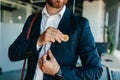 Future money and life with bitcoin concept. Investor man putting bitcoin to suit pocket, walking in office interior Royalty Free Stock Photo