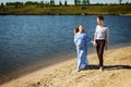 Future mother and father walking on sand holding hands together Royalty Free Stock Photo