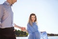 Future mother and father walking near lake holding hands together Royalty Free Stock Photo