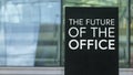 The Future of the office on a sign outside a modern glass office building Royalty Free Stock Photo