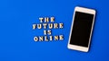 The future is online text with mobile phone. Technologies on workplace. The future is online lettering. Online education, work Royalty Free Stock Photo