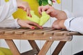 Future parents holding hands and a pair of little shoes Royalty Free Stock Photo