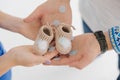 Future parents holding in their hands booties for newborn baby Royalty Free Stock Photo